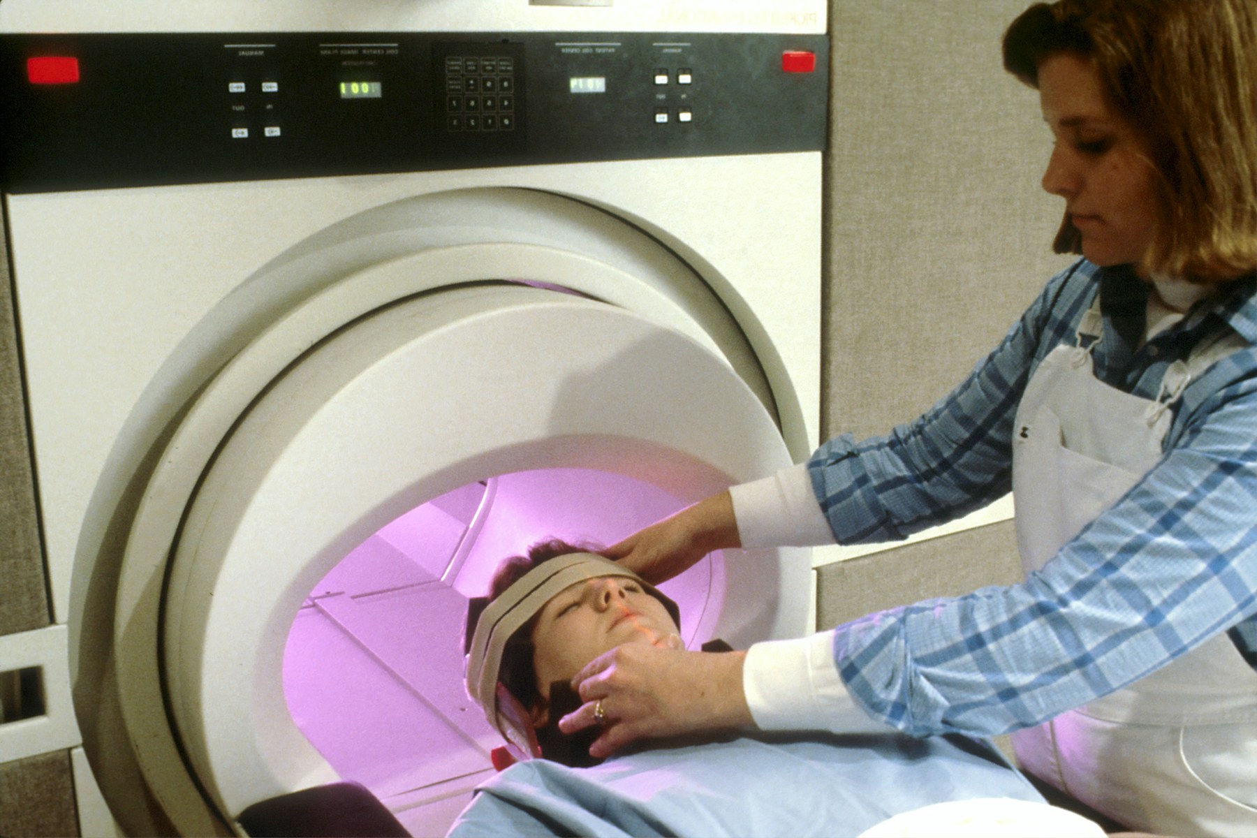 A patient is positioned inside a medical imaging scanner